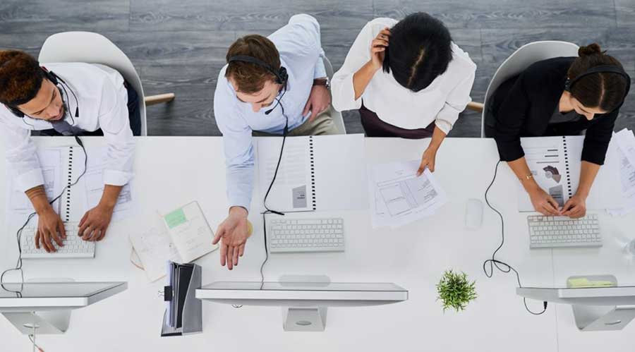 team sitting in front of computerfs